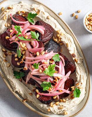 Sesame Labneh topped with roasted beetroot, pickled shallots and pine nuts