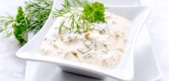 Remulada w białej kwadratowej misce z koperkiem - zdjęcie.