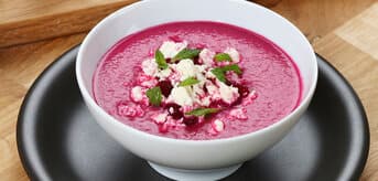 Dish with beetroot gazpacho with crumbled feta and mint