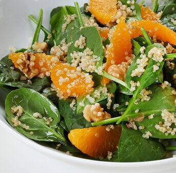Dish with baby spinach quinoa and walnut salad with parmesan yoghurt dressing