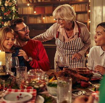 Family sitting around the dinner table at christmas, war atmosphere, people looking happy