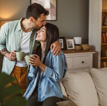 A loving couple sharing a cozy moment in their living room.