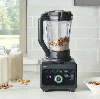 Braun PowerBlend 9 Jug blender standing on a kitchen counter next to bottles with freshly made almond milk